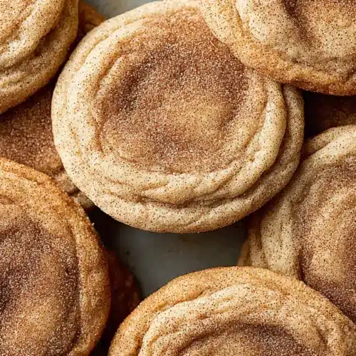 churro cookie recipe featuring plain chewy cookies coated in cinnamon sugar with soft indented centers, overhead view