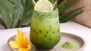 Easy Matcha Mocktail in a glass with sugared matcha rim and lemon slice