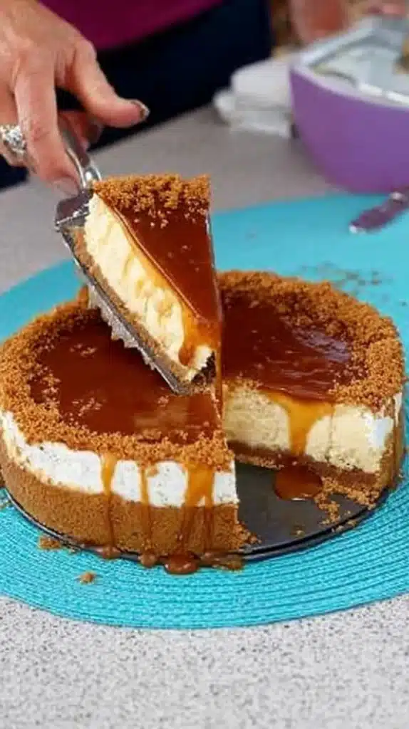 Caramel Cheesecake Tort Recipe: Simple, Luxurious slice being lifted, caramel sauce dripping over a graham crust.