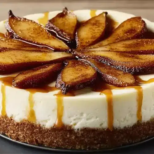 Ginger Pear Cheesecake Recipe: Simple & Stunning 5 Ginger Pear Cheesecake Recipe: Simple & Stunning with caramel drizzle and spiced pear wedges arranged on top.