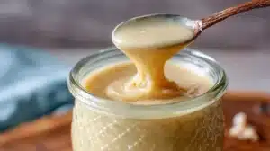 Whipped Honey Recipe: Easy, Creamy, Wonderful whipped honey recipe dripping smoothly from a spoon into a jar