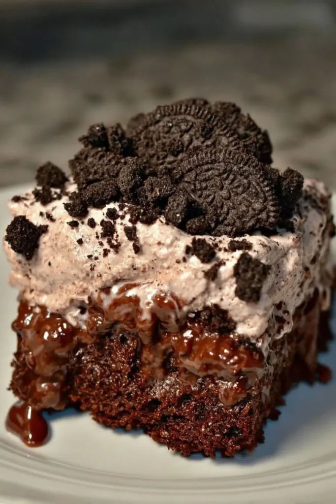 Slice of Dirt Cake Recipe on a plate with creamy chocolate filling, cookie crumbs on top, and a fudgy brownie-like base