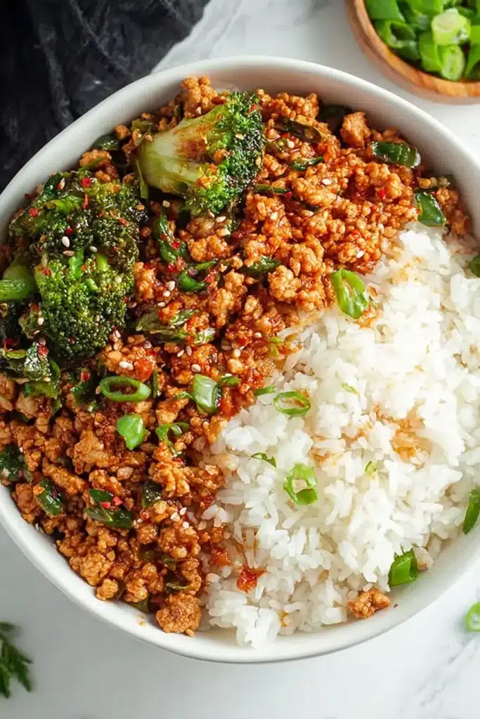 Firecracker Ground Chicken Bowl: Quick, Stunning Skillet Dinner 2 Firecracker Ground Chicken Bowl with spicy-saucy ground chicken, tender broccoli florets, scallions, and fluffy white rice