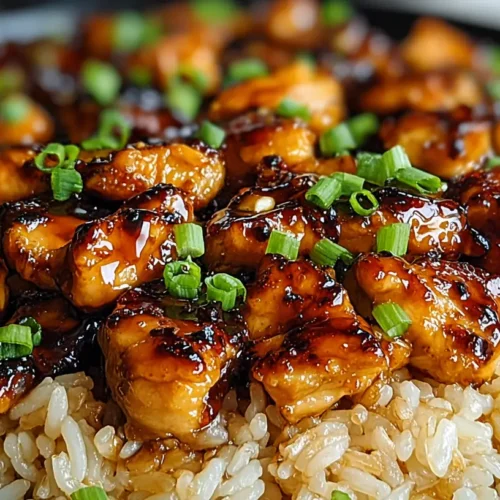 Honey BBQ Chicken Rice bowl with caramelized chicken chunks, brown rice, and sliced green onions