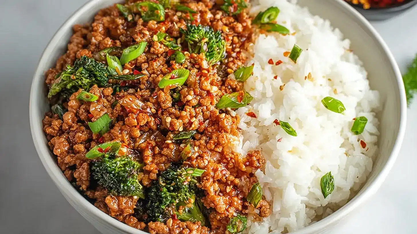 Firecracker Ground Chicken Bowl: Quick, Stunning Skillet Dinner 1 Firecracker Ground Chicken Bowl served with spicy ground chicken, broccoli, sesame seeds, green onions, and steamed white rice