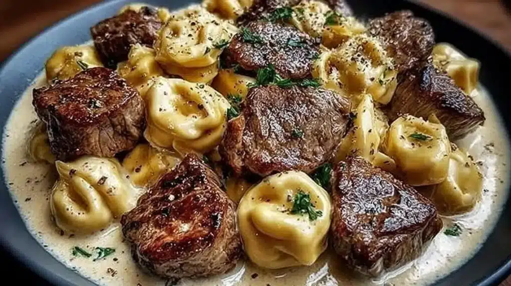 Delicious Garlic Steak Tortellini in creamy sauce served on a plate