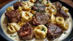 Delicious Garlic Steak Tortellini in creamy sauce served on a plate