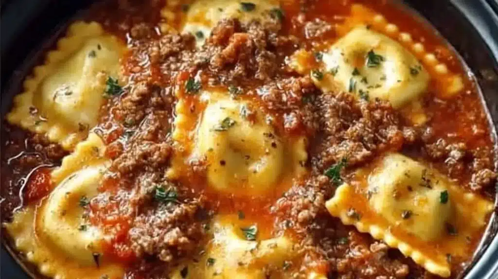 Crockpot Ravioli Lasagna served with fresh herbs and cheese on top