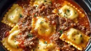 Crockpot Ravioli Lasagna (Easy Lazy Lasagna!) Crockpot Ravioli Lasagna served with fresh herbs and cheese on top