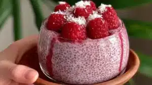 Delicious Raspberry Chia Pudding served in a bowl with fresh raspberries and mint.