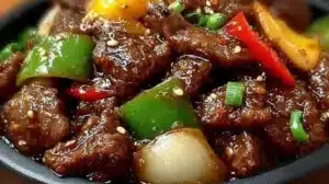 Sizzling Chinese Pepper Steak with Onions served on a plate