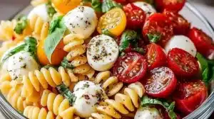 Colorful Caprese Pasta Salad with fresh ingredients like mozzarella, tomatoes, and basil