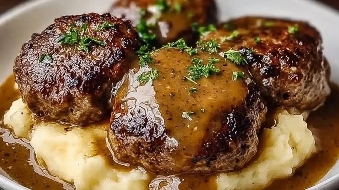 The Best Hamburger Steak Recipe for a Cozy Family Dinner 1 Juicy Hamburger Steak served with gravy and side dishes