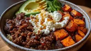 High Protein Hot Honey Beef Bowl garnished with fresh ingredients in a vibrant dish.