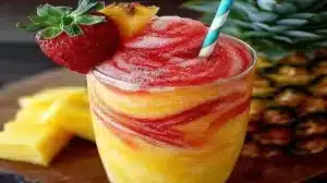 Refreshing Pineapple Strawberry Swirled Slushie in a glass