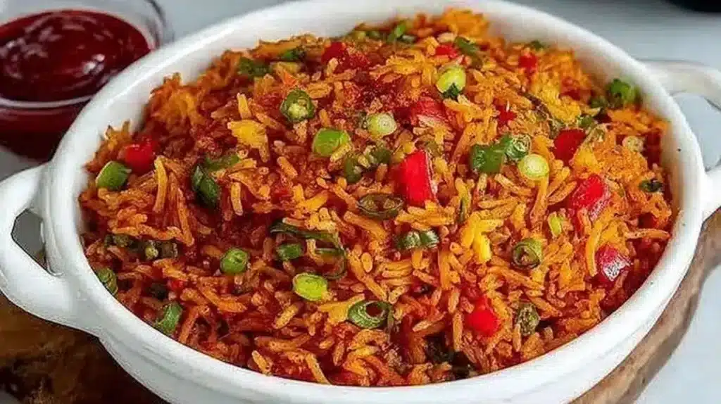 Bowl of colorful Schezwan Fried Rice garnished with vegetables and spices