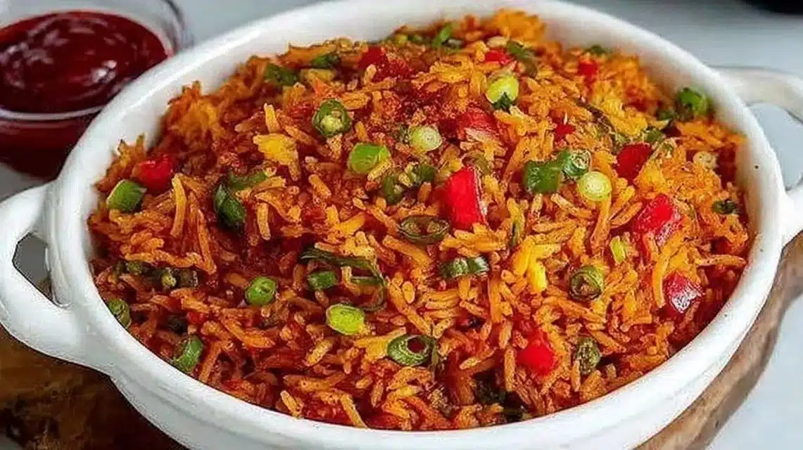 Bowl of colorful Schezwan Fried Rice garnished with vegetables and spices