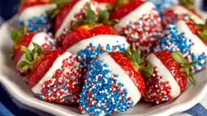 Festive 4th of July chocolate covered strawberries on a decorated table.
