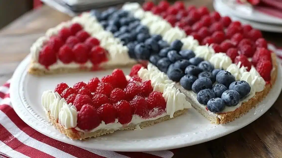 Colorful American Flag Fruit Pizza with fresh fruit toppings on a cookie crust