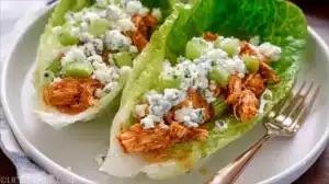 Best Buffalo Chicken Lettuce Wraps for Quick Flavor Packed Meals Buffalo Chicken Lettuce Wraps served on a plate with fresh veggies