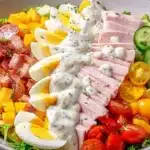 A vibrant Chef Salad featuring lettuce, tomatoes, cucumbers, and various toppings.
