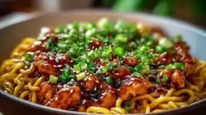 Delicious sticky garlic chicken noodles served in a bowl