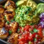Low-carb fish taco bowls topped with fresh ingredients and lime