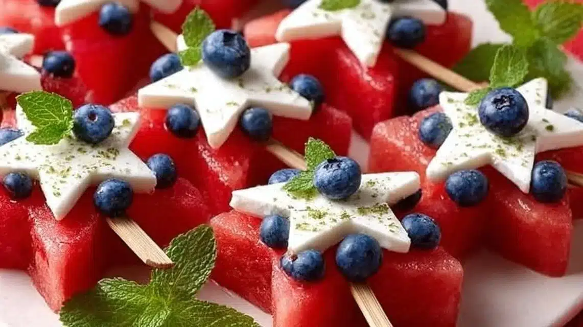 Patriotic watermelon feta skewers with blueberries and fresh mint for a festive touch.