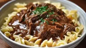 Simple Slow Cooker Beef and Noodles for Weeknight Dinners Delicious slow cooker beef noodles served in a bowl with toppings.