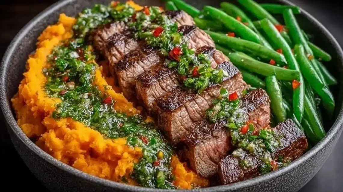 Steak bowl featuring sweet potato mash and garlic green beans for a healthy meal.