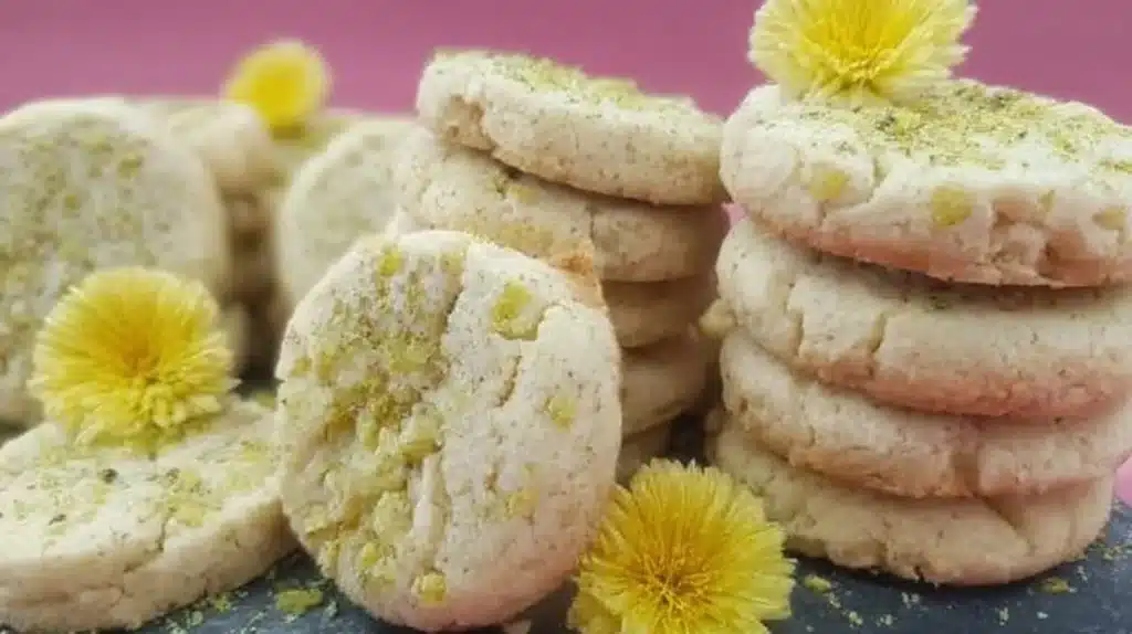 Plate of homemade Dandelion Cookies with fresh dandelion blooms