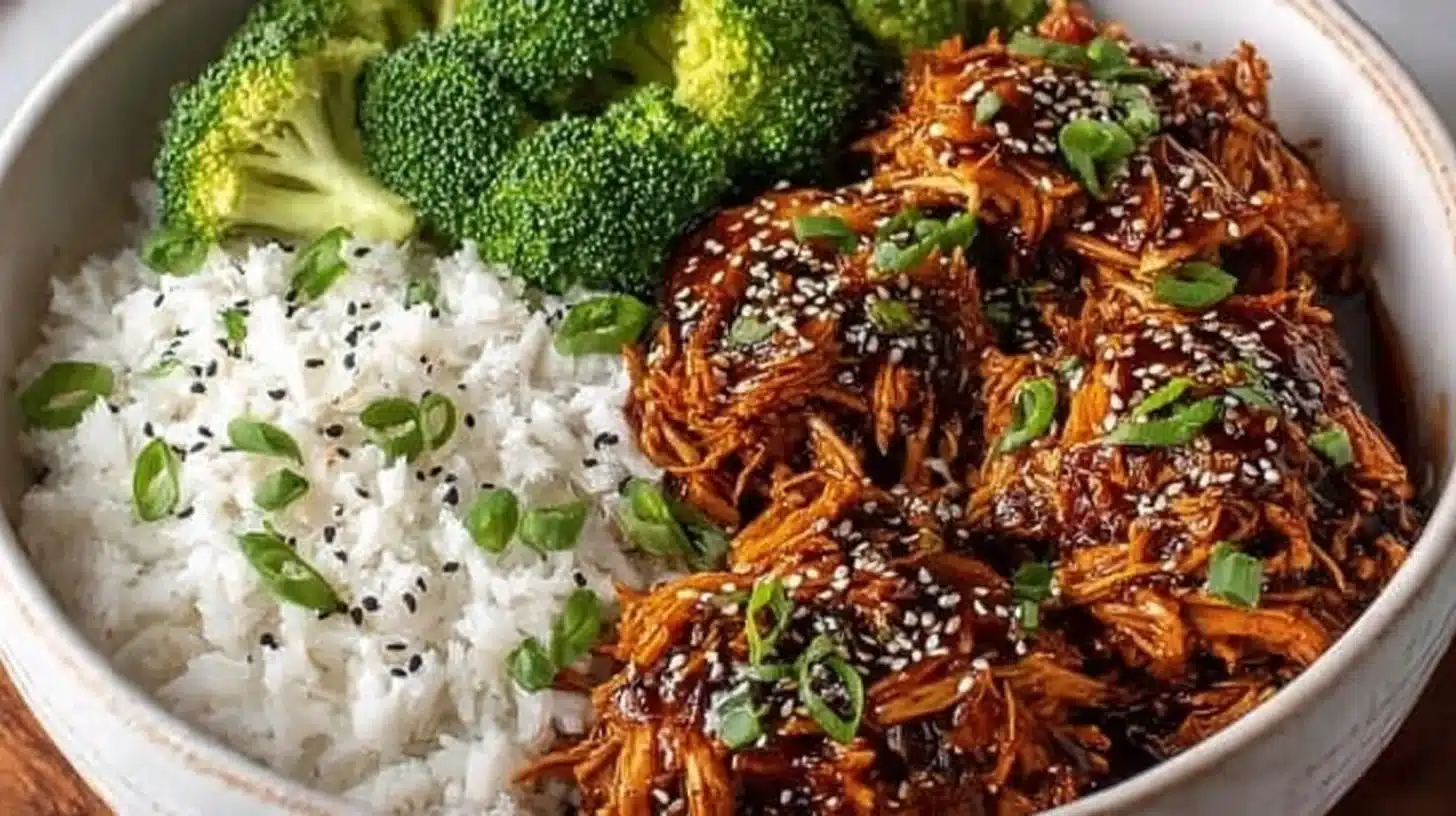 Slow cooker honey garlic chicken served on a plate with vegetables