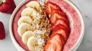 Strawberry Banana Smoothie Bowl with Creamy Yogurt and Fresh Toppings Delicious Strawberry Banana Smoothie Bowl topped with fresh fruits and granola