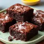 Delicious fudgy chocolate brownies on a parchment paper background