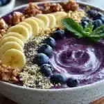 Delicious blueberry smoothie bowl topped with fresh berries and granola